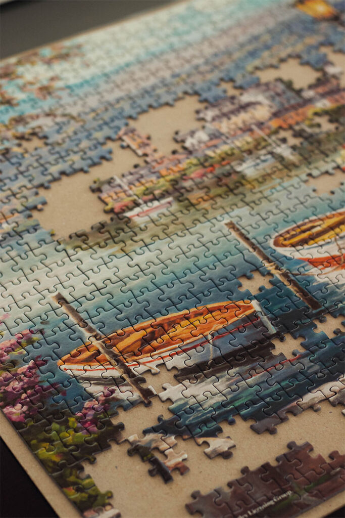 A jigsaw puzzle of a boat in a harbour