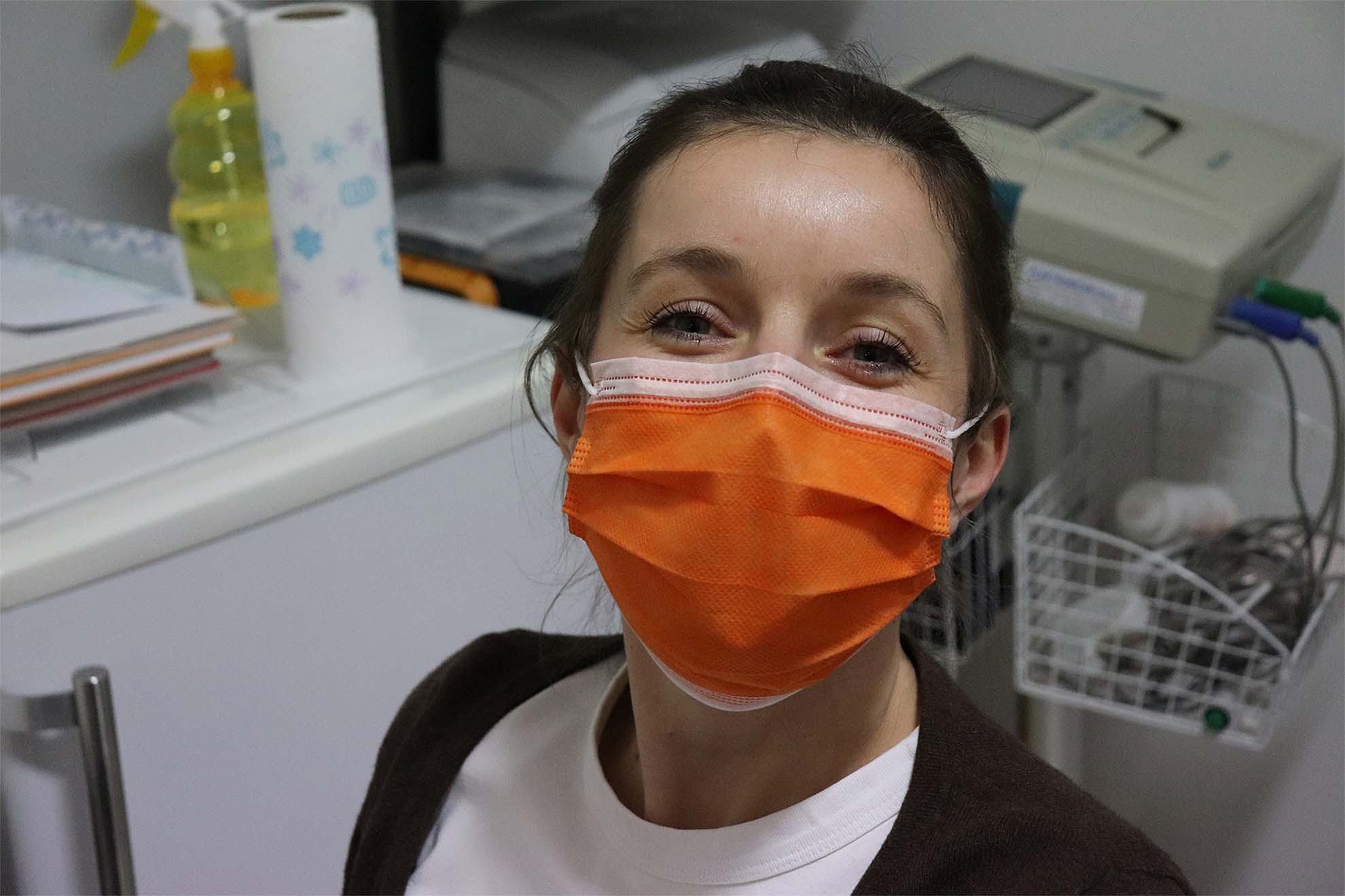 A nurse wearing an orange face mask
