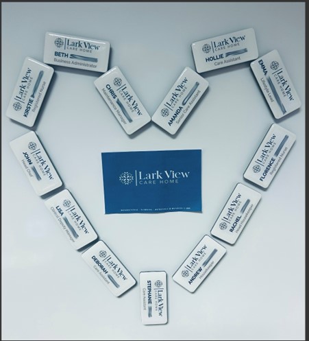 Larkview card with name badges surrounding in a heart shape.