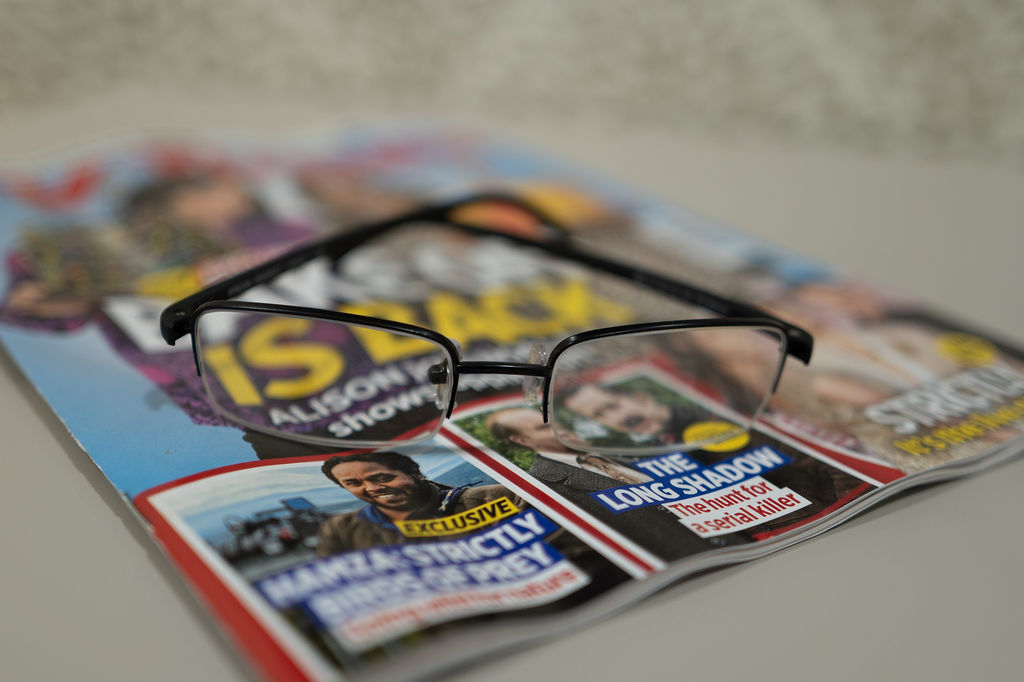 A pair of glasses resting on a magazine
