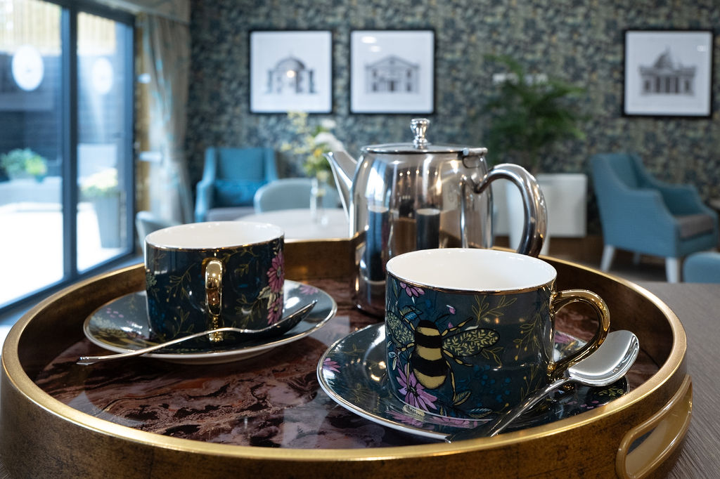 Blue tea cups with bee motifs