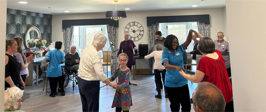 dancing with residents at lark view's one year anniversary open day