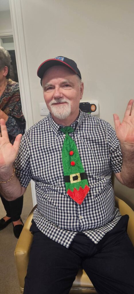 resident with a christmas tie on