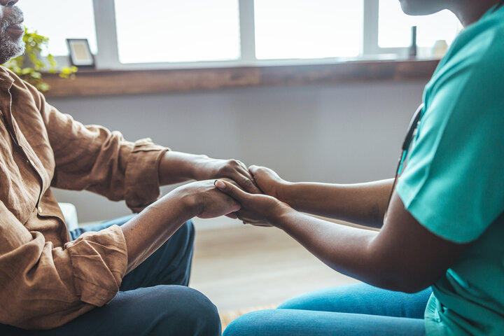 nurse holding resident hand